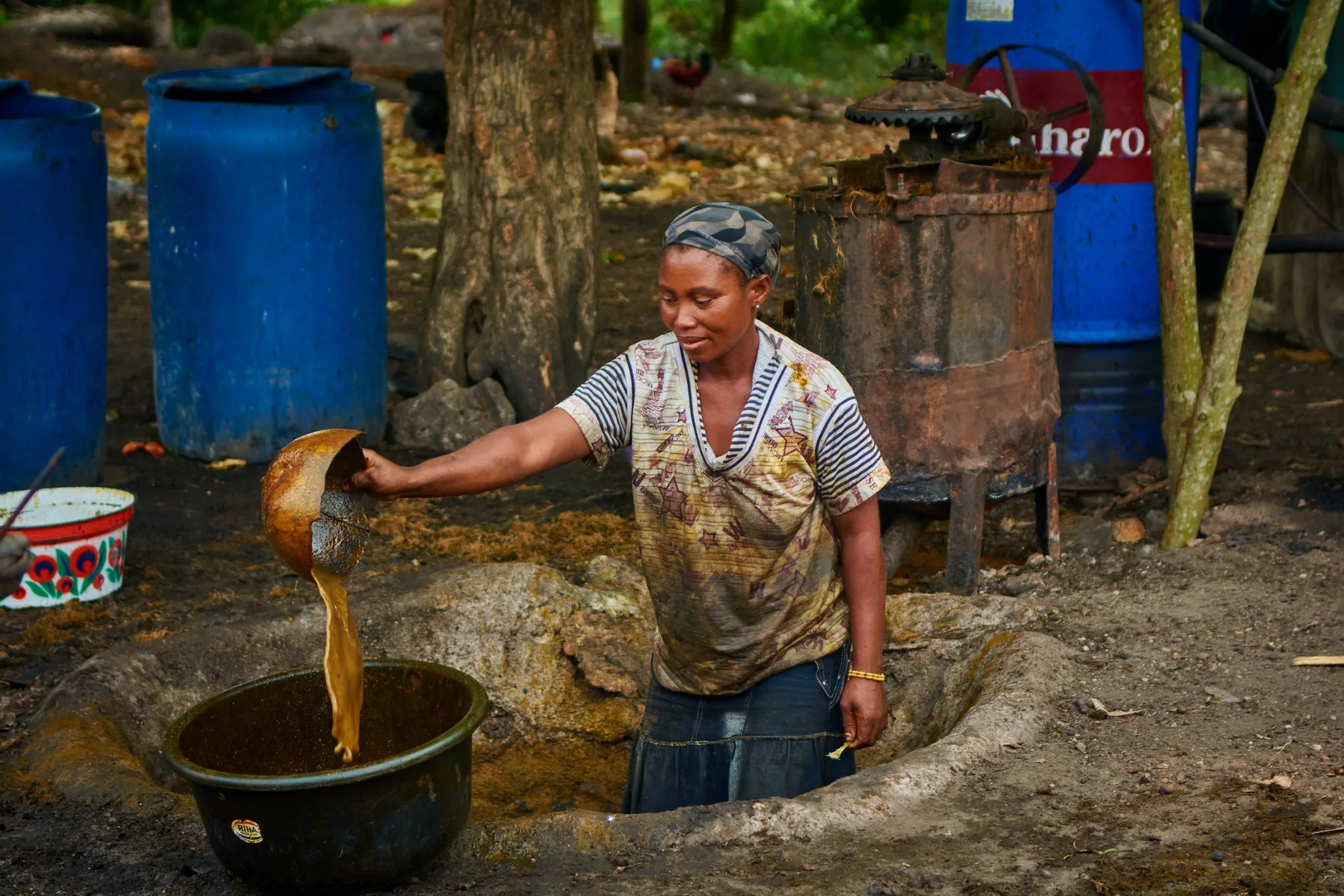 A woman working at the palm oil press in Apapa Odan